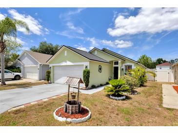 Charming single-story home featuring a well-maintained lawn and a whimsical wishing well accent at 108 Orion Way, Sanford, FL 32773