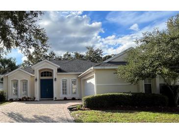 Charming single-story home with a blue door and lush landscaping at 1432 Stargazer Ter, Sanford, FL 32771
