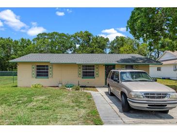 Charming single-story home with a well-maintained lawn and colorful exterior accents at 2213 Bates Ave, Eustis, FL 32726