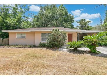 Charming single-story home featuring a well-maintained yard and attached carport at 2918 Croton Rd, Apopka, FL 32703