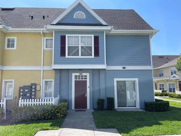Inviting townhouse featuring colorful facade, well-maintained landscaping, and a cozy, welcoming entrance at 4001 San Sabastian Dr # 107, Kissimmee, FL 34741
