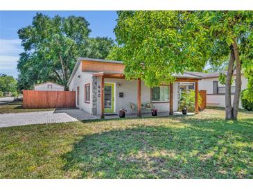 Charming single-story home featuring a covered front porch, a well-manicured lawn, and inviting curb appeal at 440 E Crystal Lake St, Orlando, FL 32806