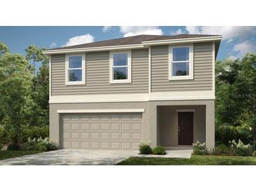 Charming two-story home with a two-car garage and covered entryway, perfect for a growing Gathering at 4622 Snapdragon Pl, Lake Hamilton, FL 33851