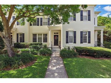Charming two-story home with a landscaped front yard and inviting entrance, enhanced by a mature tree at 5489 Baldwin Park St, Orlando, FL 32814