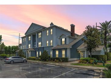 Charming condo building showcasing classic design elements, manicured landscaping, and ample parking space at 7630 Heritage Crossing Way # 302, Reunion, FL 34747