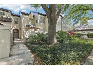 Charming townhome exterior featuring a landscaped front yard and inviting entrance with a covered patio at 1578 Farrindon Cir # 1578, Lake Mary, FL 32746