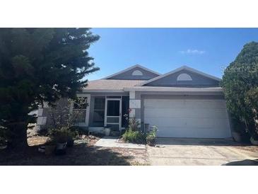 Charming single-story home with a well-maintained lawn and attached two-car garage at 2857 Woodruff Dr, Orlando, FL 32837