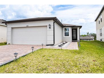 Charming single-Gathering home with a two-car garage, walkway, and well-maintained landscaping at 30498 Pintail Dr, Leesburg, FL 34748