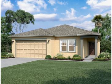 Charming single-story home with a two-car garage, manicured lawn, and tasteful landscaping at 3053 Daffodil Dr, Lake Hamilton, FL 33851