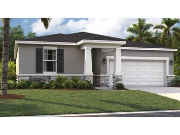 Charming one-story home with a gray exterior, dark shutters and an attached two-car garage at 398 Eventide Ave, Mascotte, FL 34753