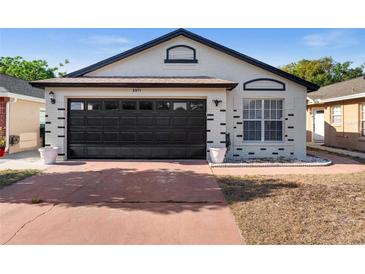 Charming single-story home featuring a two-car garage and nicely painted exterior at 9911 Dean Cove Ln, Orlando, FL 32825