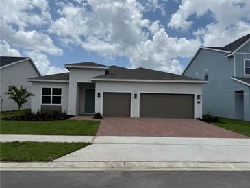 Modern single-story home featuring a two-car garage and well-maintained landscaping at 1016 Gloryland Ct, Sanford, FL 32771