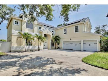 Elegant home with a three-car garage, well-maintained landscaping, and solar panels at 1302 Shelter Rock Rd, Orlando, FL 32835