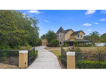 Stunning two-story home with a beautiful turret and well-manicured front yard at 1415 Brumley Rd, Chuluota, FL 32766