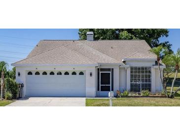 Charming single-story home with an attached two-car garage and well-manicured lawn at 3780 Ventura Cove Dr, Orlando, FL 32822