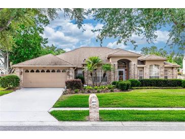 Charming single-story brick home with a well-manicured lawn and mature landscaping, offering great curb appeal at 603 Yorkshire Dr, Oviedo, FL 32765