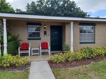 Inviting front porch featuring cozy chairs and colorful landscaping at 207 Esplanade Way # 101, Casselberry, FL 32707