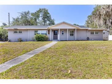 Charming single-story home with a well-maintained lawn and inviting front porch at 1101 Mizell Rd, Leesburg, FL 34748