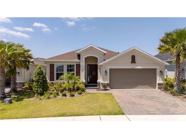 Charming one-story home with a two-car garage, beautiful landscaping and a brick paved driveway at 2126 Ridge Pointe Ln, Clermont, FL 34715