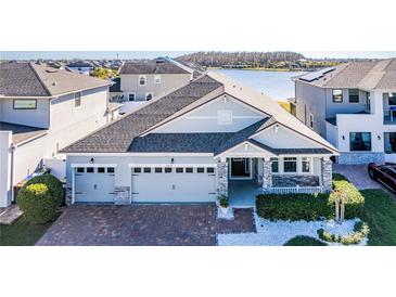 Charming single-Gathering home with a brick driveway, a three-car garage, and a well-maintained front yard at 2417 Annacella Ave, Kissimmee, FL 34741