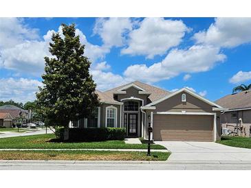 Charming single-story home with a well-manicured lawn and attached two-car garage at 2752 Bellewater Pl, Oviedo, FL 32765
