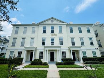 Attractive two-story townhouse featuring a symmetrical facade, manicured lawn, and inviting entrance at 276 Celebration Blvd, Celebration, FL 34747
