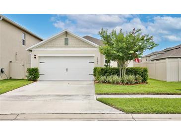 Charming home showcasing a two-car garage, well-manicured lawn, and decorative landscaping adding curb appeal at 3945 Angola Ln, Sanford, FL 32771