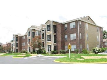 Well maintained apartment complex exterior with parking at 4225 Thornbriar Ln # 305, Orlando, FL 32822