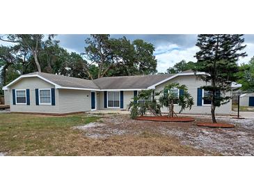 Charming single-story home featuring neutral siding, dark shutters, manicured landscaping and a well-maintained lawn at 131 Lake Charles Rd, Deland, FL 32724