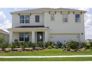 Two-story home with a two-car garage, complemented by a well-manicured lawn and inviting landscaping at 2155 Kalin Way, Tavares, FL 32778