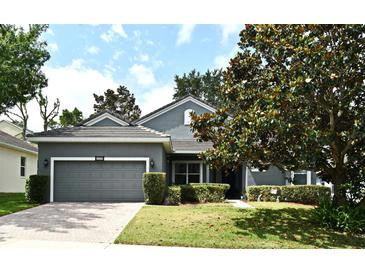 Charming single-story home with a well-manicured lawn, mature trees, and a two-car garage at 2503 Squaw Crk, Clermont, FL 34711