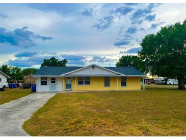 Charming single-story home featuring a cozy front porch and well-maintained lawn at 606 E Central Ave, Eagle Lake, FL 33839