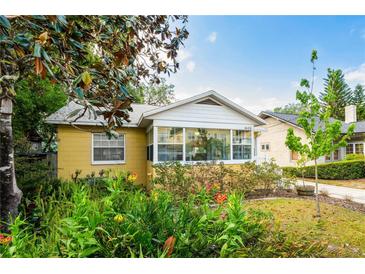 Charming yellow home featuring a white roof, number display, and manicured landscaping for enhanced curb appeal at 1624 Park Lake St, Orlando, FL 32803