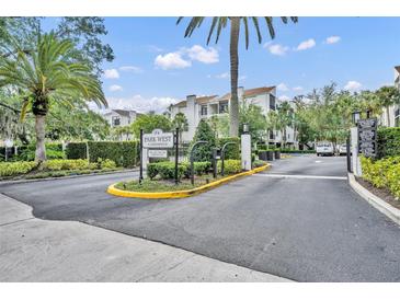Park West entrance showing signage, lush landscaping, and buildings on a sunny day at 300 Carolina Ave # 304, Winter Park, FL 32789