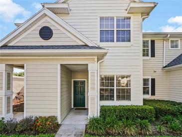 Charming two-story condo with a green front door and well-manicured landscaping at 430 Southern Pecan Cir # 101, Winter Garden, FL 34787