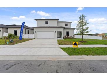 Beautiful two-story home featuring a large driveway, well-manicured lawn, and a welcoming two-car garage at 6340 Chorus Dr, Mascotte, FL 34753