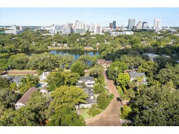 Stunning aerial view of the neighborhood, showcasing its lush greenery, lake and proximity to downtown Orlando at 100 Kennison Dr, Orlando, FL 32801