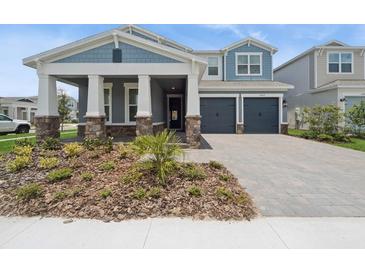 Charming two-story home with a two-car garage, beautiful stone accents, and a well-manicured front yard at 13187 Telsen St # 38, Winter Garden, FL 34787