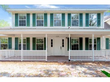 Charming two-story home with green shutters and inviting front porch, perfect for enjoying the outdoors at 2320 Red Ember Rd, Oviedo, FL 32765