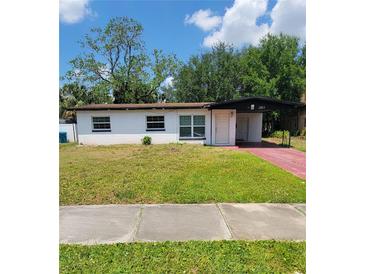 Charming single-story home featuring a well-maintained lawn and covered parking at 3463 Fekany Pl, Orlando, FL 32805