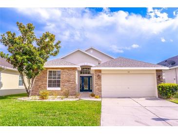 Charming single-story home with stone accents, manicured lawn, and a two-car garage at 113 Venetian Bay Cir, Sanford, FL 32771