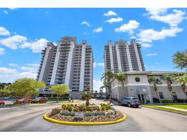 Stunning high-rise condo building with well-manicured landscaping and a central fountain at 13415 Blue Heron Beach Dr # 409, Orlando, FL 32821