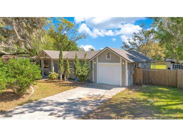 Charming single-story home with attached garage and well-manicured lawn at 2927 Ahern Dr, Orlando, FL 32817