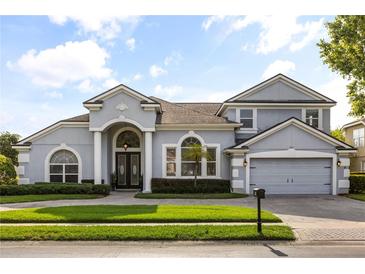 Beautifully landscaped single-Gathering home with a two-car garage and a well-manicured lawn at 3891 Brantley Place Cir, Apopka, FL 32703