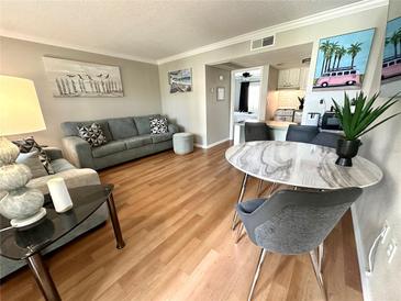 Inviting living room features hardwood floors, modern decor, and neutral paint, creating a welcoming and stylish space at 109 Oyster Bay Cir # 120, Altamonte Springs, FL 32701