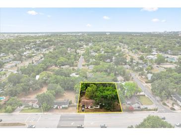 Aerial view of a charming home with mature trees and landscaping, close to amenities at 2312 Corrine Dr, Orlando, FL 32803
