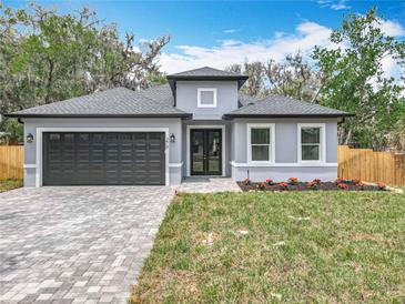 Charming one-story home with a gray exterior, complemented by a well-manicured lawn and a paved driveway at 278 Acorn Dr, Longwood, FL 32750