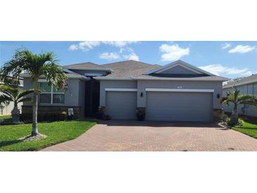 Charming single-story home featuring a well-manicured lawn, two-car garage, and brick driveway at 3986 Bedford Ave, Winter Haven, FL 33884