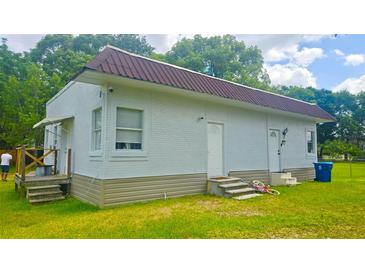 Charming home featuring a brick exterior, new roof, and a well-maintained lawn at 412 Bay Nw St, Fort Meade, FL 33841