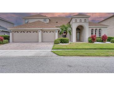 Charming home with a three car garage, arched entry, and well-manicured lawn at 839 Timber Isle Dr, Orlando, FL 32828